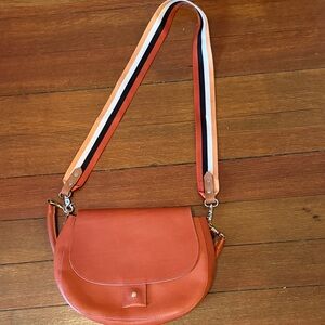 Elegant Orange Crossbody Bag with Striped Strap